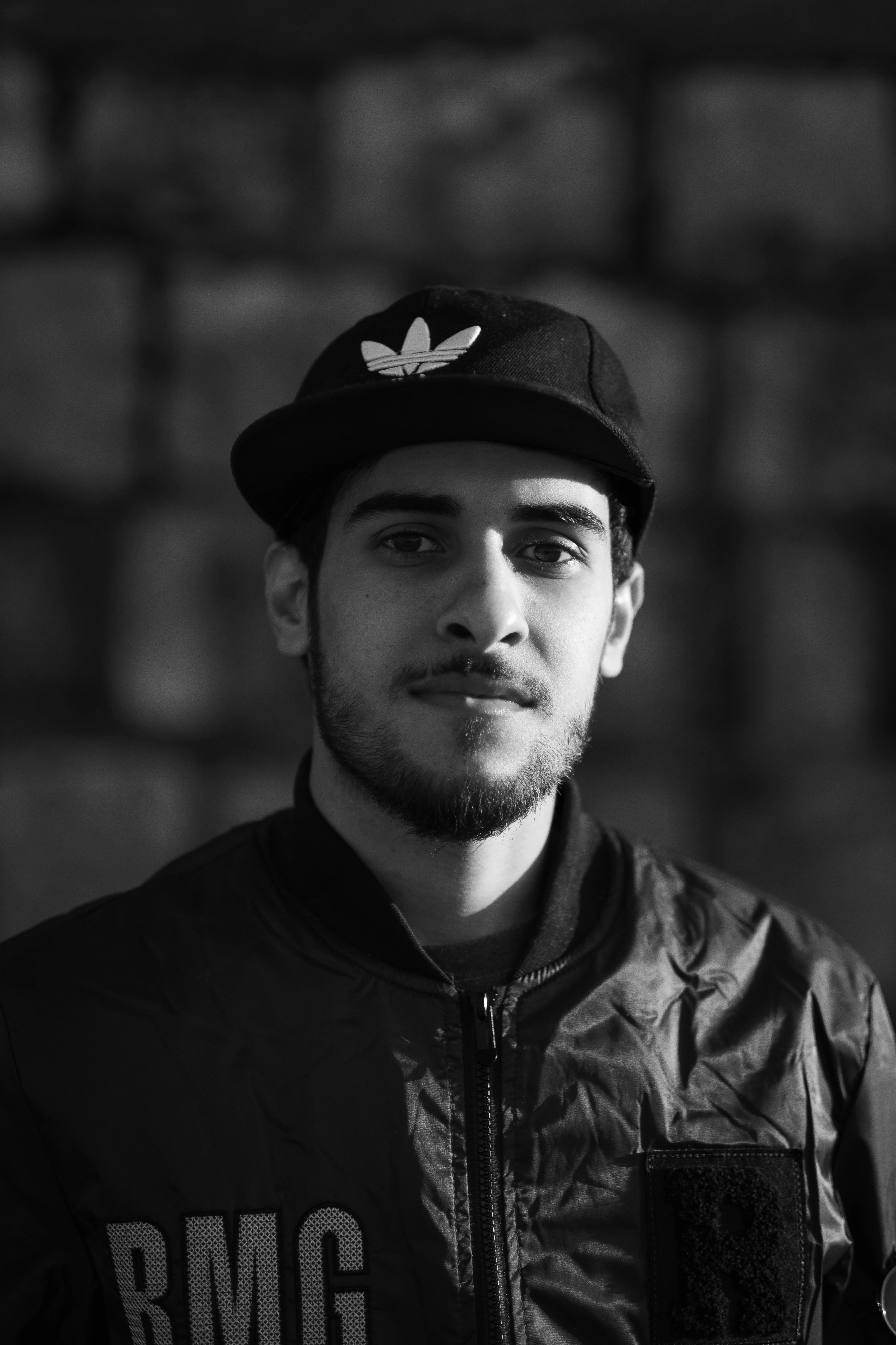 a young man wearing a hat and jacket